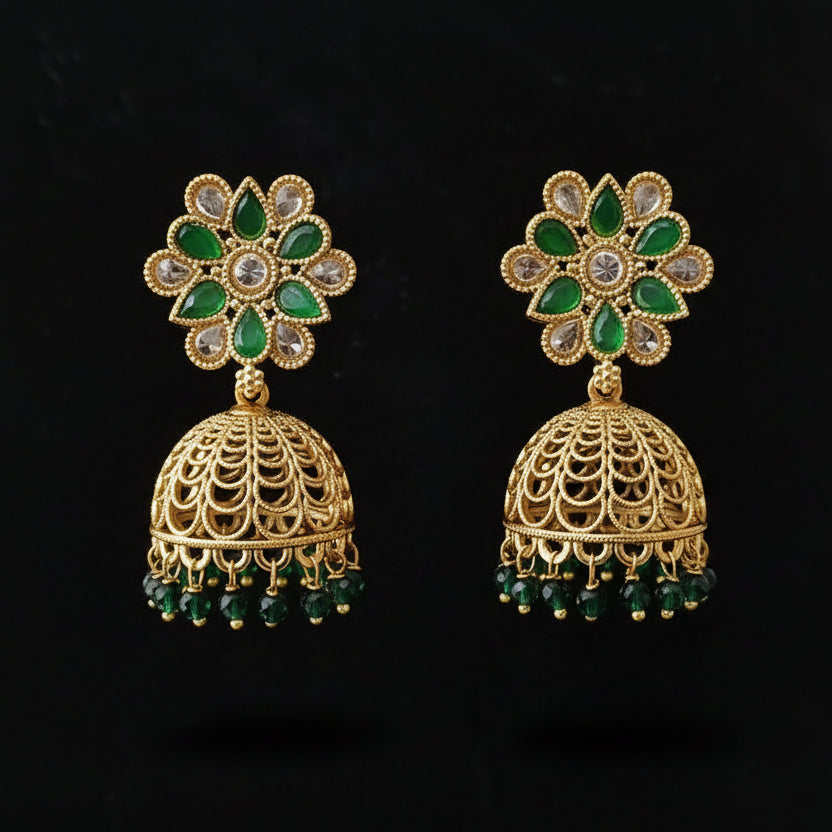 Gold and green earrings on a black background