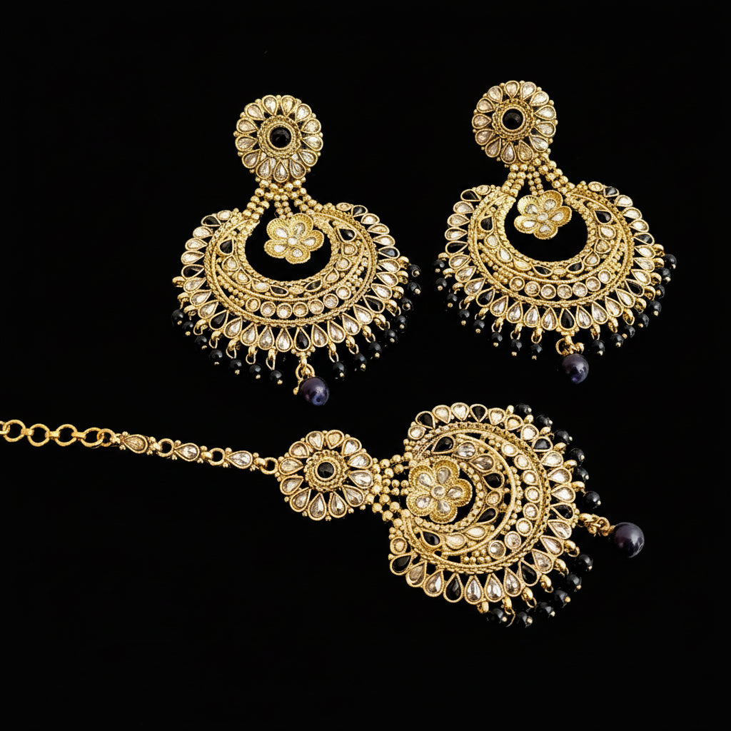 Ornate gold and black jewelry set with 'SAHELI' branding on a gray background
