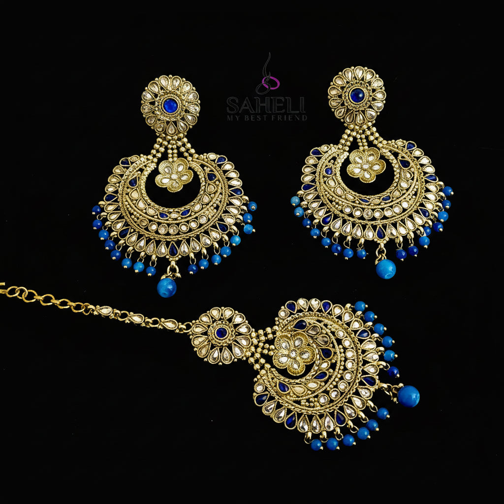 Ornate gold and blue jewelry set with 'SAHELI' branding on a gray background