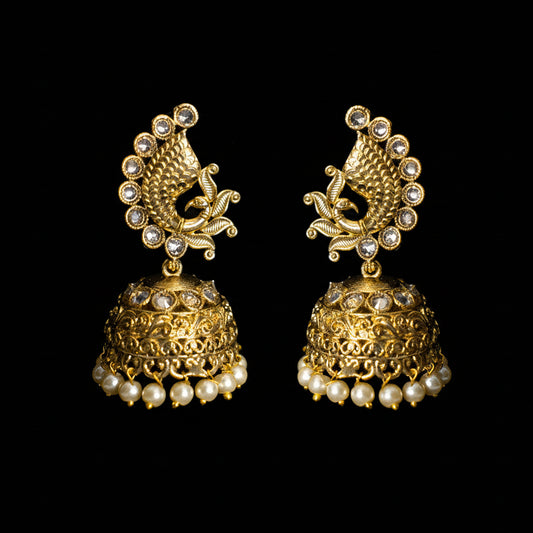 Gold and pearl earrings on a black background with 'Saheli' branding.