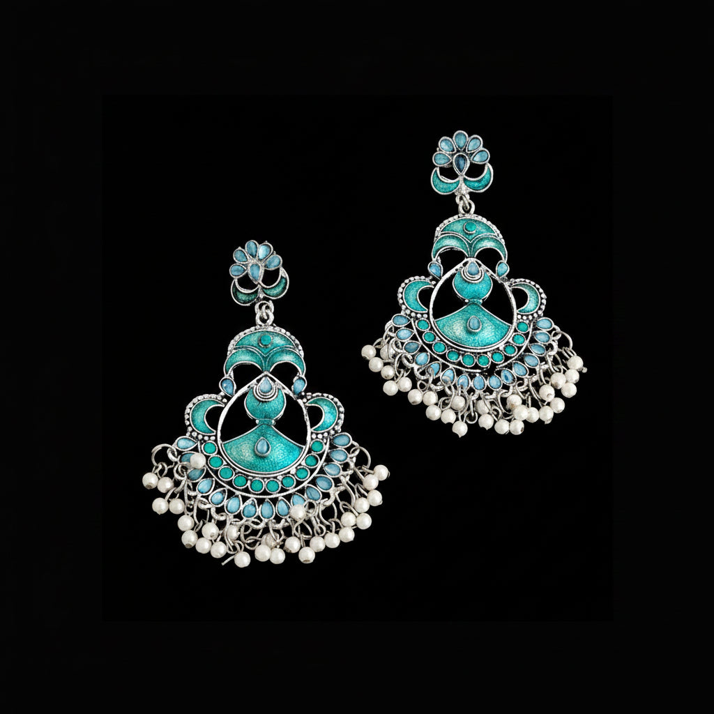 Turquoise and silver earrings with pearl accents on a gray background, branded 'Saheli'.