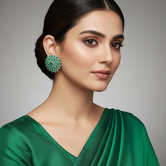 Pair of green floral earrings on a gray background with 'SAHELI' branding.