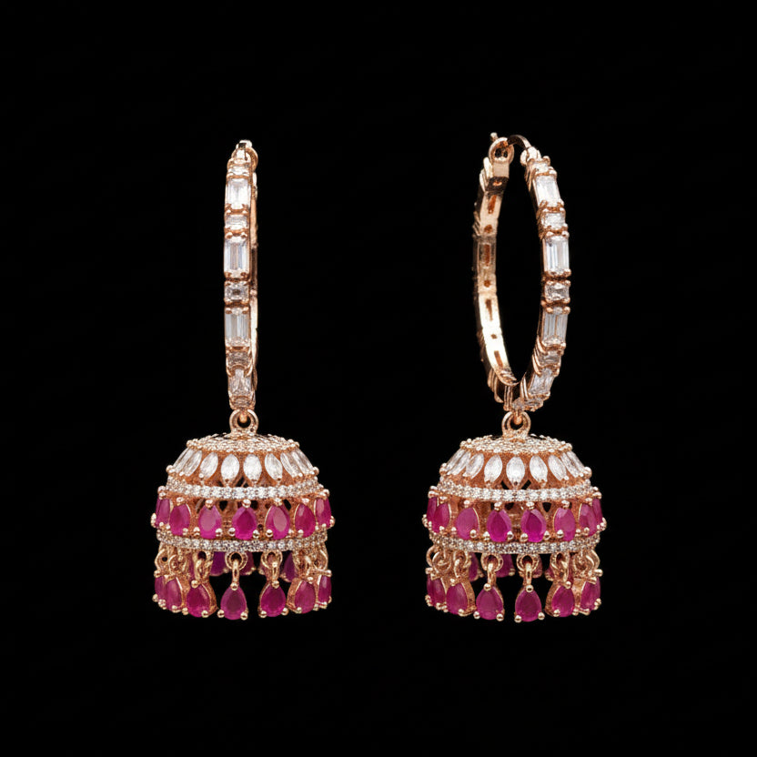 Rose gold and pink gemstone earrings on a black stand with 'SAHELI' branding.