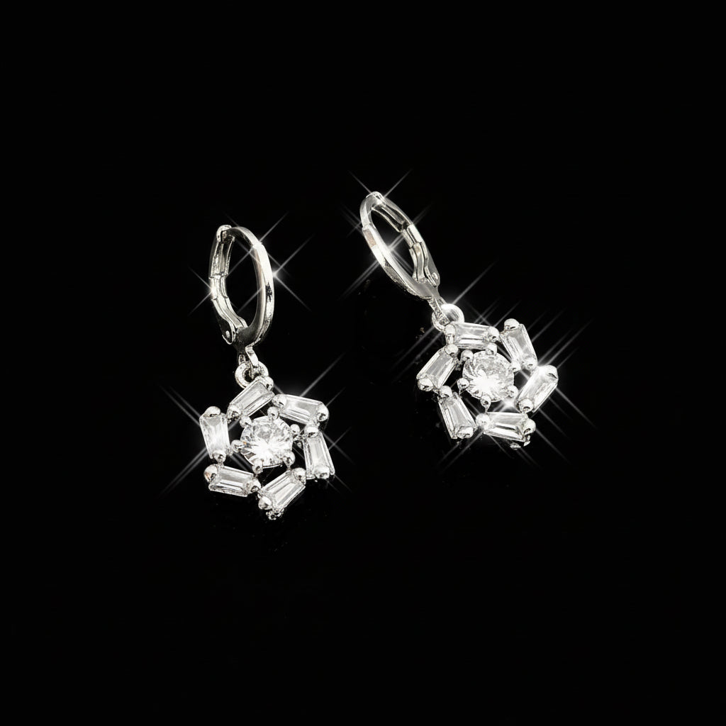 Silver earrings with gemstones on a gray background, featuring the brand 'Saheli'.