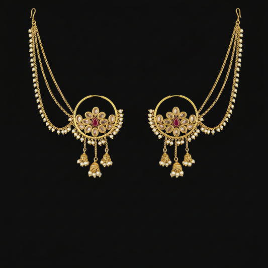 Gold necklace with red gemstones on a gray background, featuring the brand 'Saheli'.