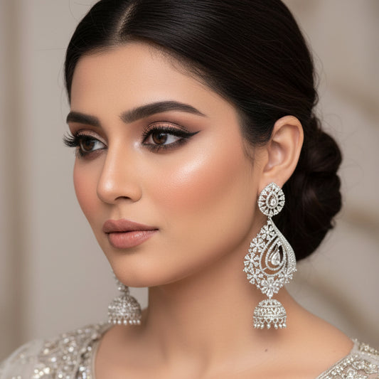 Pair of silver earrings on a dark gray background