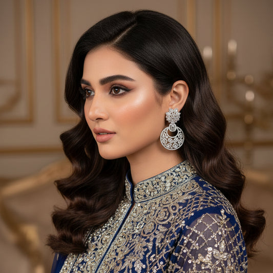 Pair of diamond earrings on a dark gray stand
