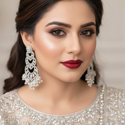 Pair of silver and pearl earrings on a dark background