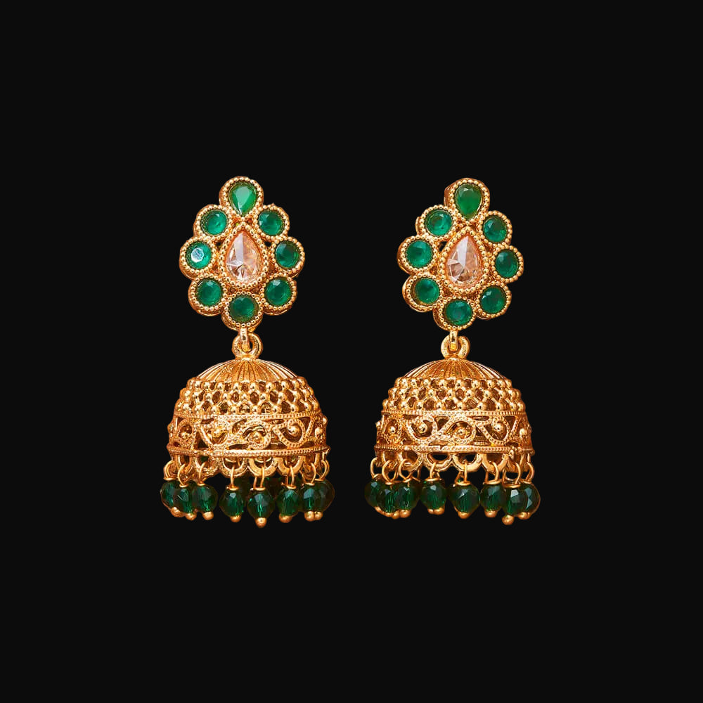 Gold and green earrings on a brown background
