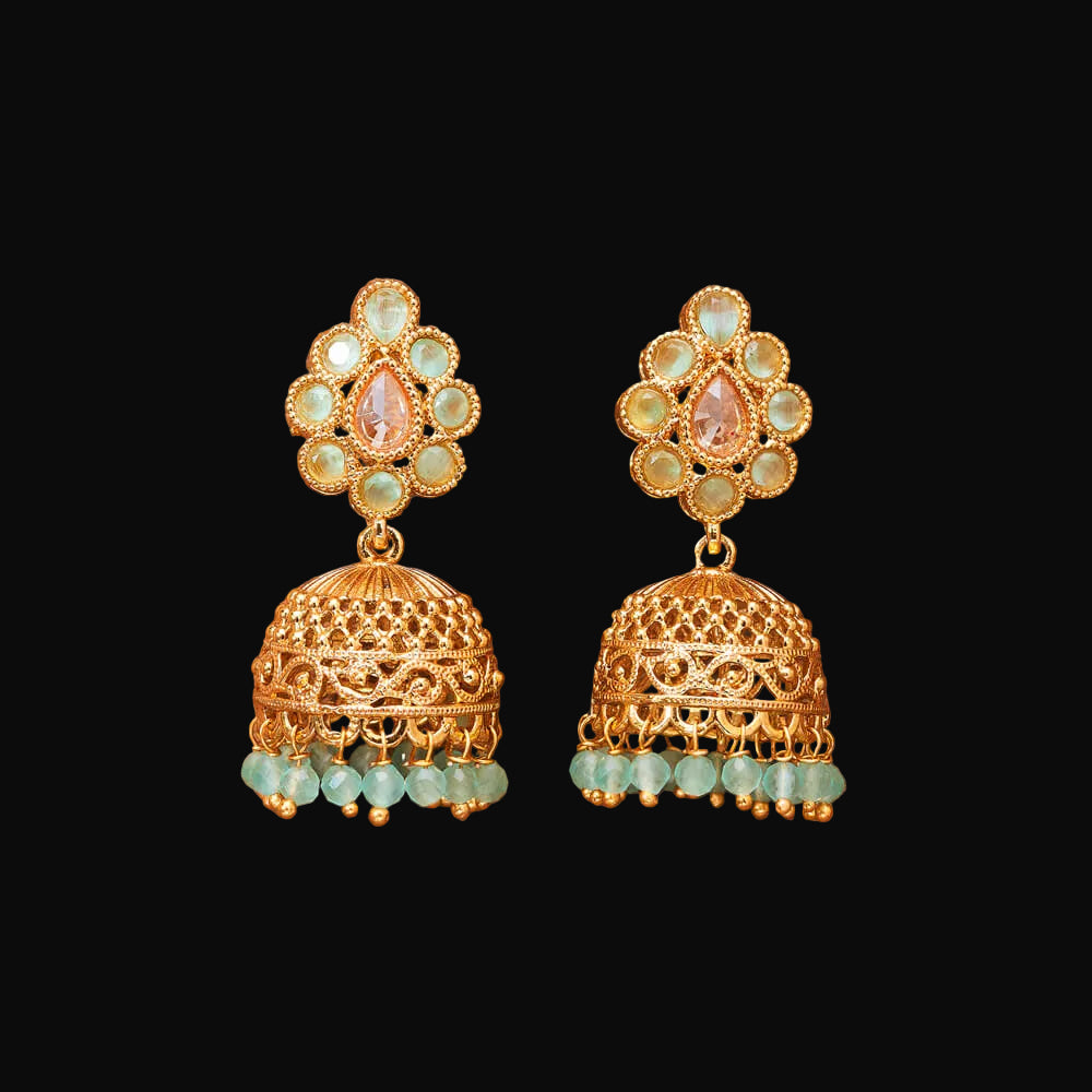Gold and green beaded earrings on a brown background