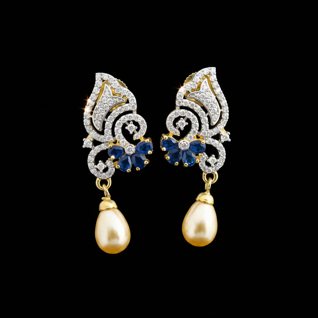 A pair of gold and silver drop earrings with blue stone accents and teardrop pearl-like drops, displayed on a gray stand against a gray background with the SAHELL MY BEST FRIEND logo above.