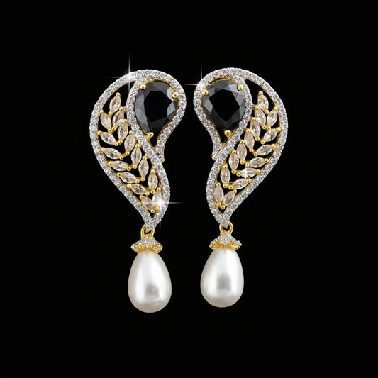 A pair of gold and crystal drop earrings with white pearl teardrops, displayed on a black stand against a dark gray background. The brand logo 'SAHELI MY BEST FRIEND' is visible in the top left corner.