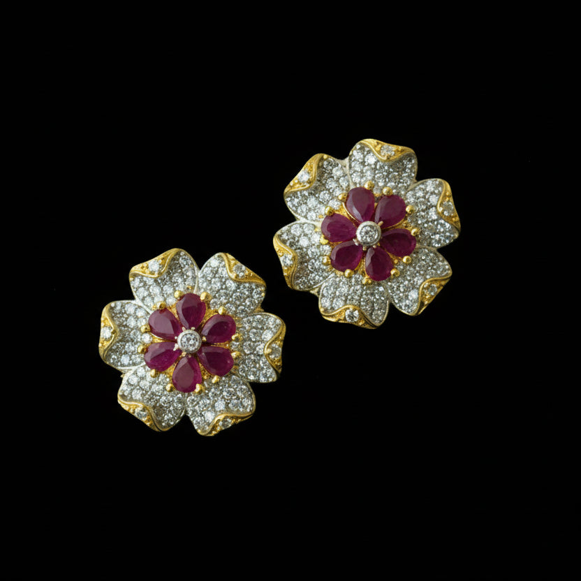 Flower-shaped earrings with red centers and gold accents on a black background with 'SAHELI' branding.