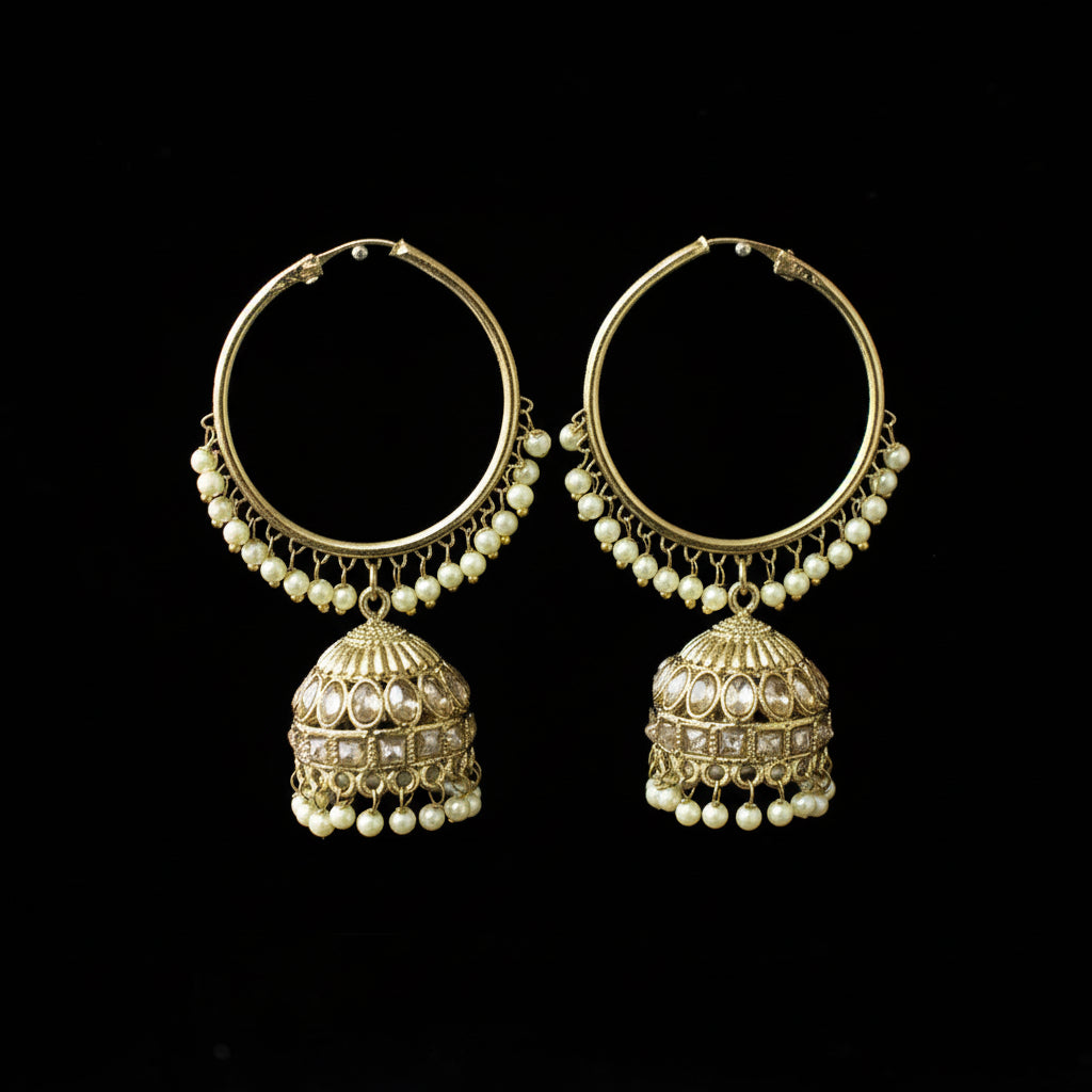 Pair of gold hoop earrings with pearl drops on a black background