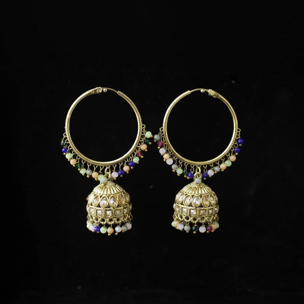 Pair of gold hoop earrings with jhumka designs on a black background