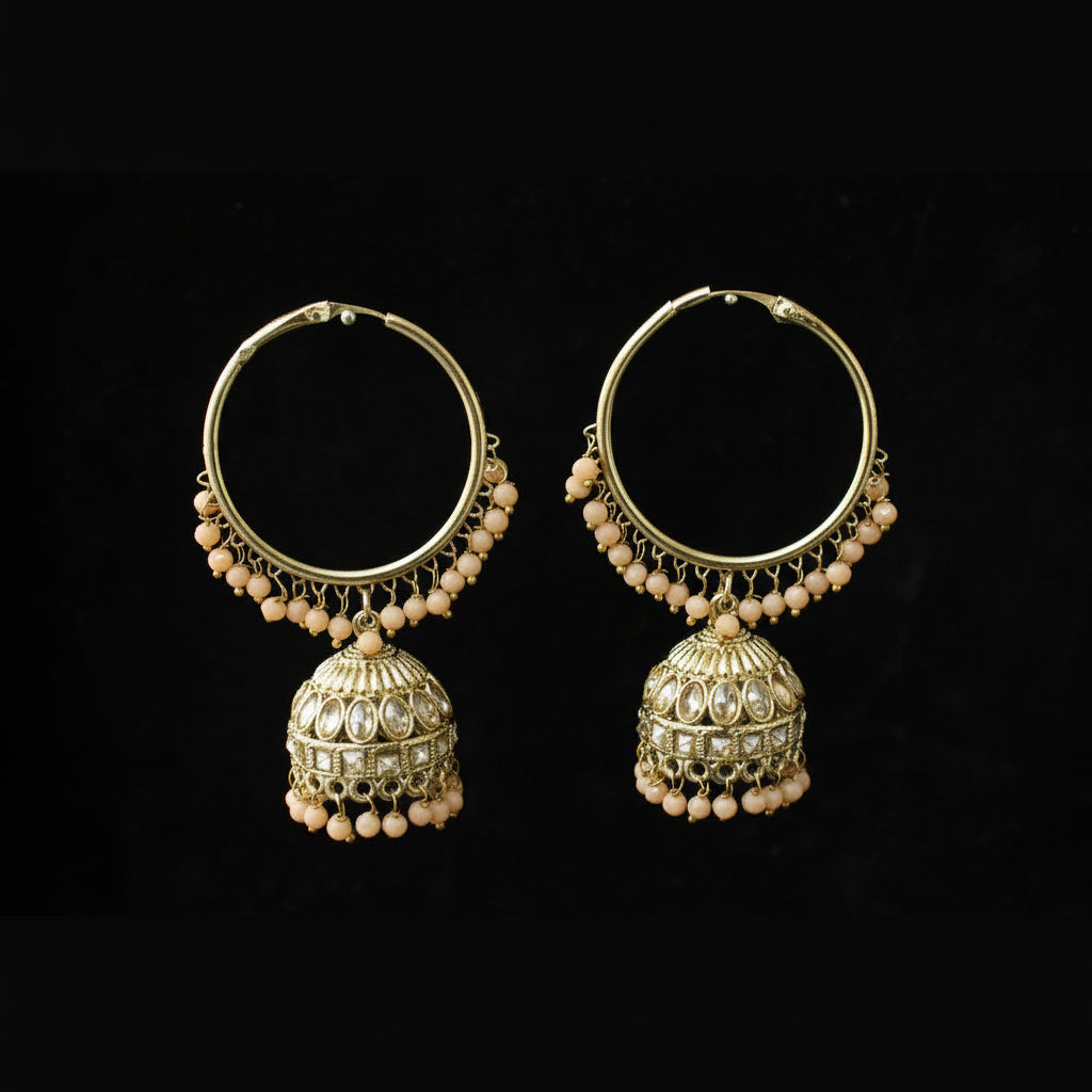 Pair of gold hoop earrings with pearl accents on a black background