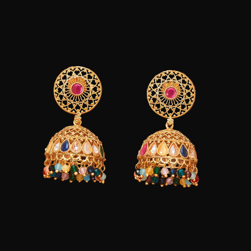 Gold earrings with colorful gemstones on a brown background