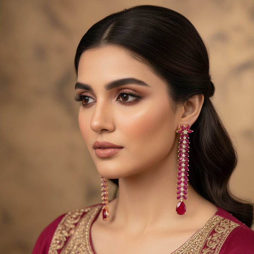 Pair of earrings with red gemstones on a dark background