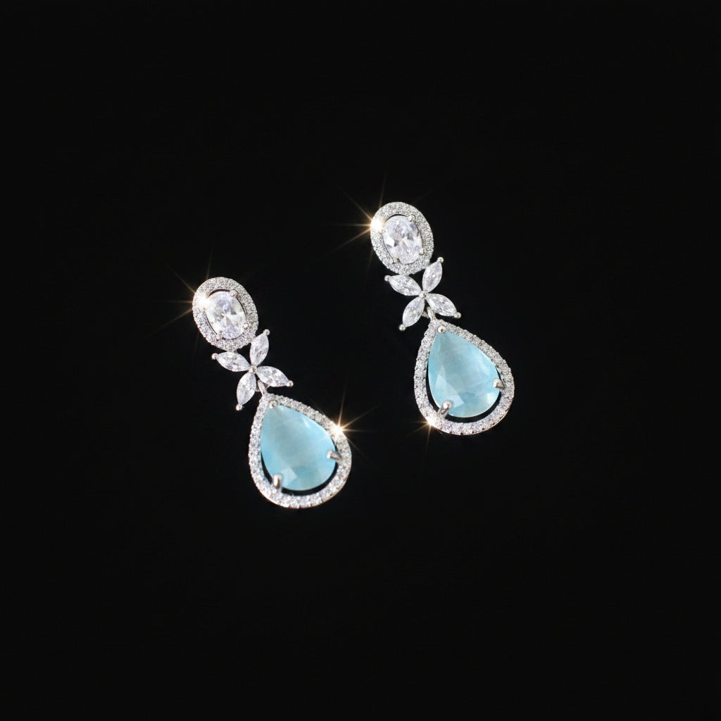 Pair of earrings with turquoise stones on a dark background
