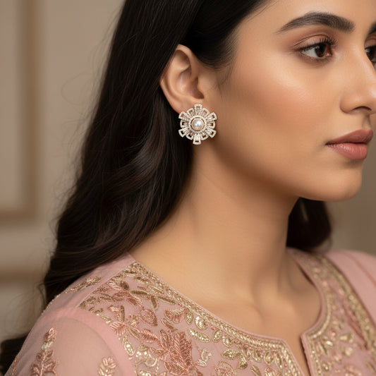 Pair of decorative earrings with pearls on a black background