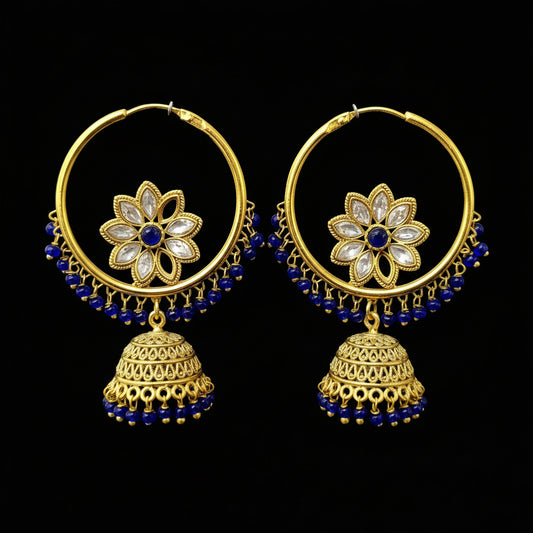Gold hoop earrings with floral designs and blue beads on a black background