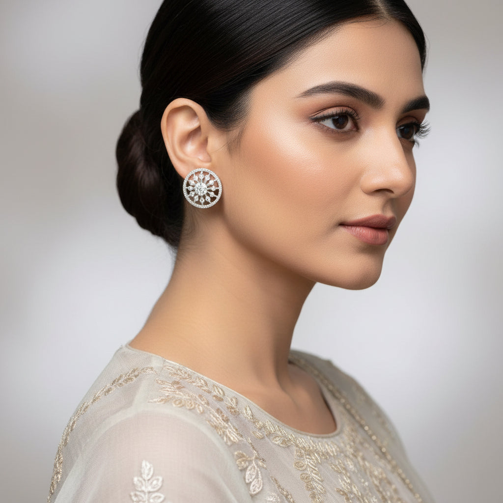 Pair of silver earrings with gemstones on a dark gray background
