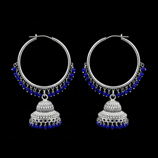 Silver hoop earrings with blue beads and jhumkas on a black background, branded 'Saheli'.