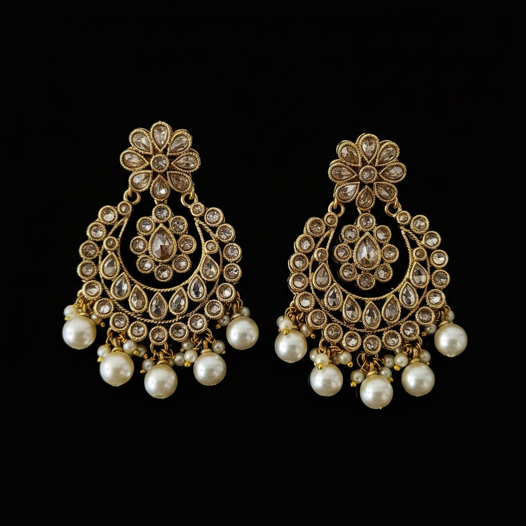Gold and pearl earrings with 'SAHELI' branding on a dark background