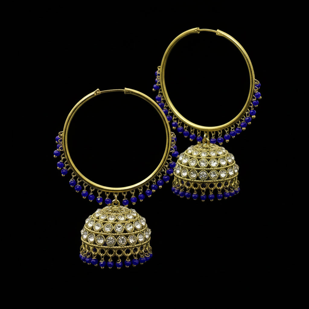 Gold and blue earrings on a black stand with 'SAHELLI' branding.