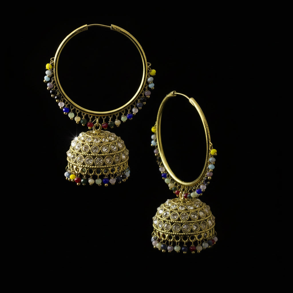 Gold hoop earrings with spherical embellishments on a black stand, branded 'SAHELI'.