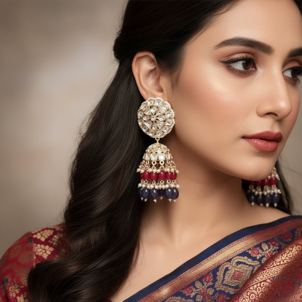 Pair of ornate earrings with gemstones on a dark background