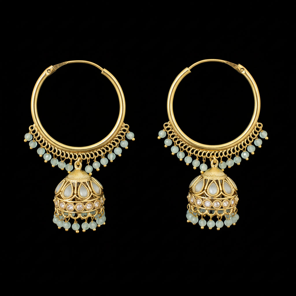 Gold hoop earrings with green gemstones on a black background