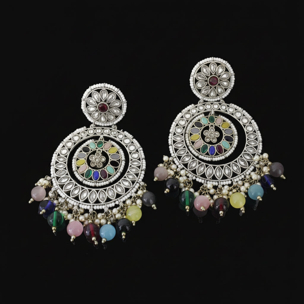 Ornate earrings with colorful beads on a dark background, featuring the brand 'Saheli'.