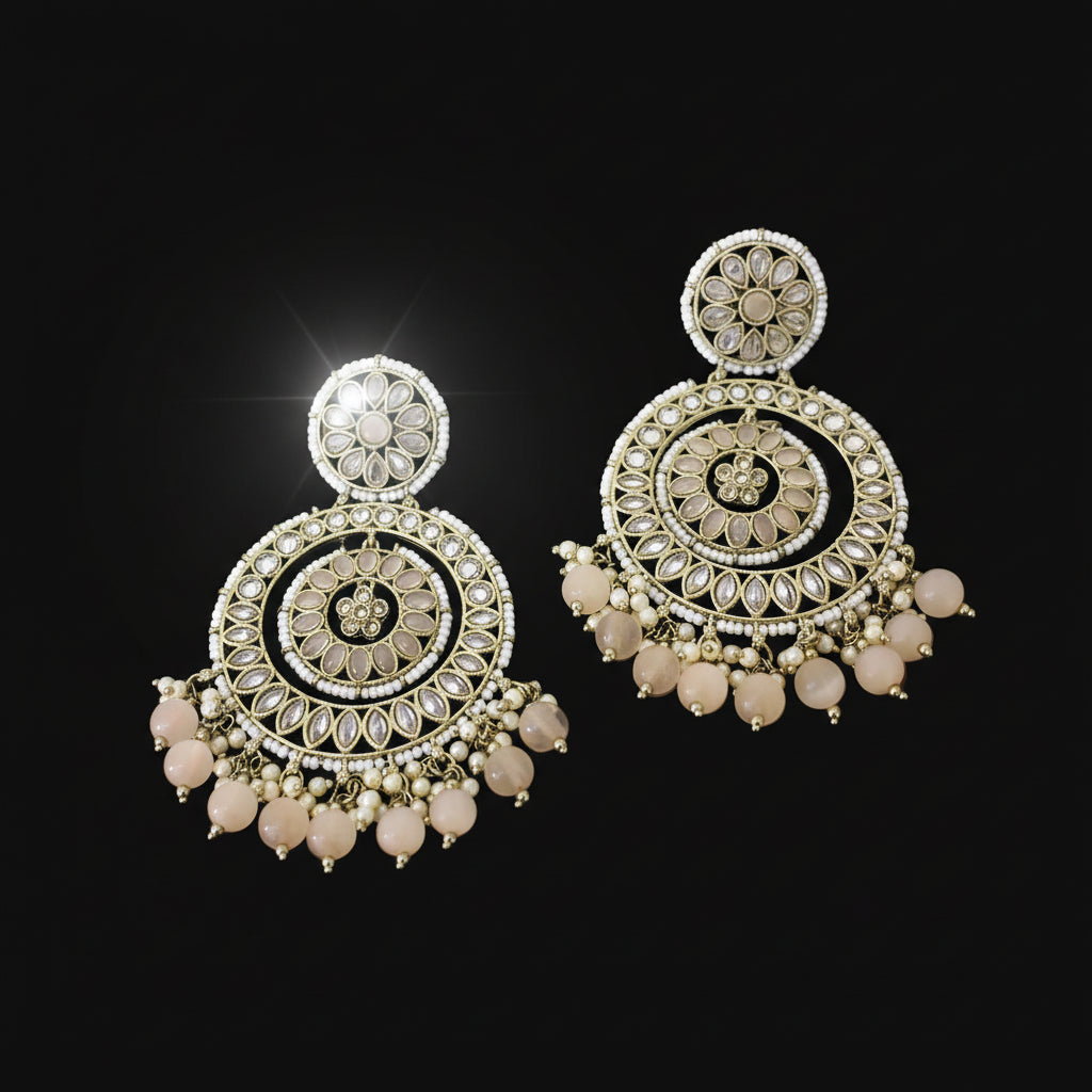Ornate earrings with gold and black design on a dark background, branded 'Saheli'.