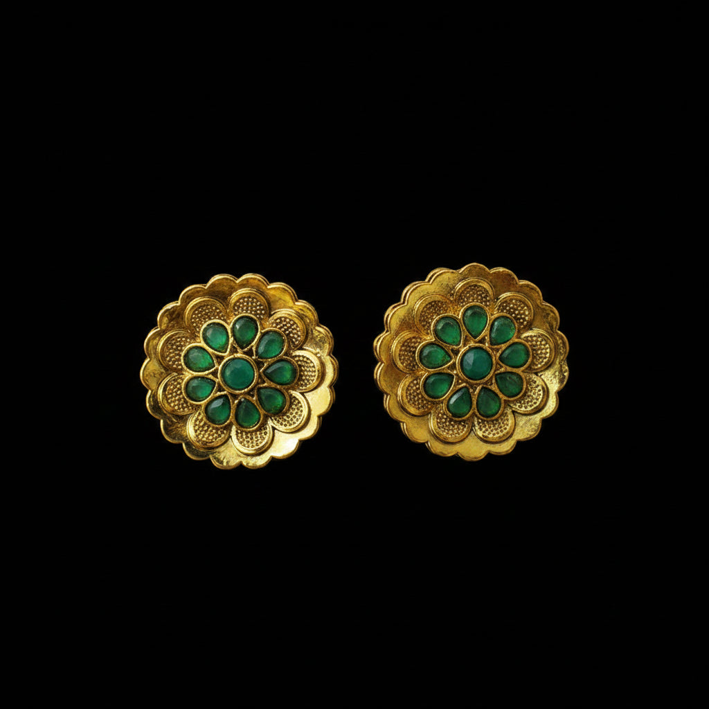 Gold earrings with green gemstones on a dark background, featuring the brand 'Saheli'.