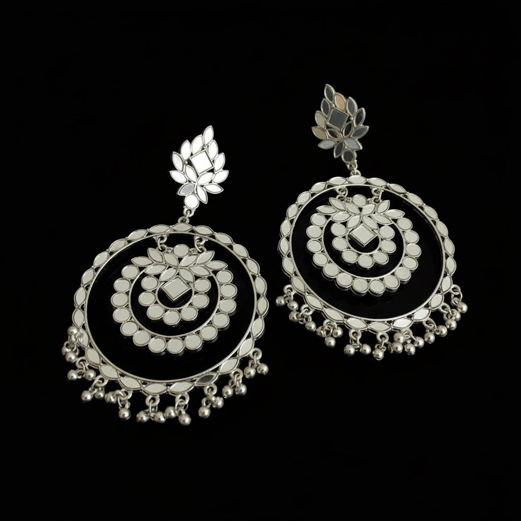 Pair of silver earrings on a black background