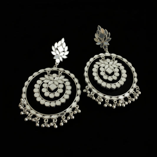 Pair of silver earrings on a black background