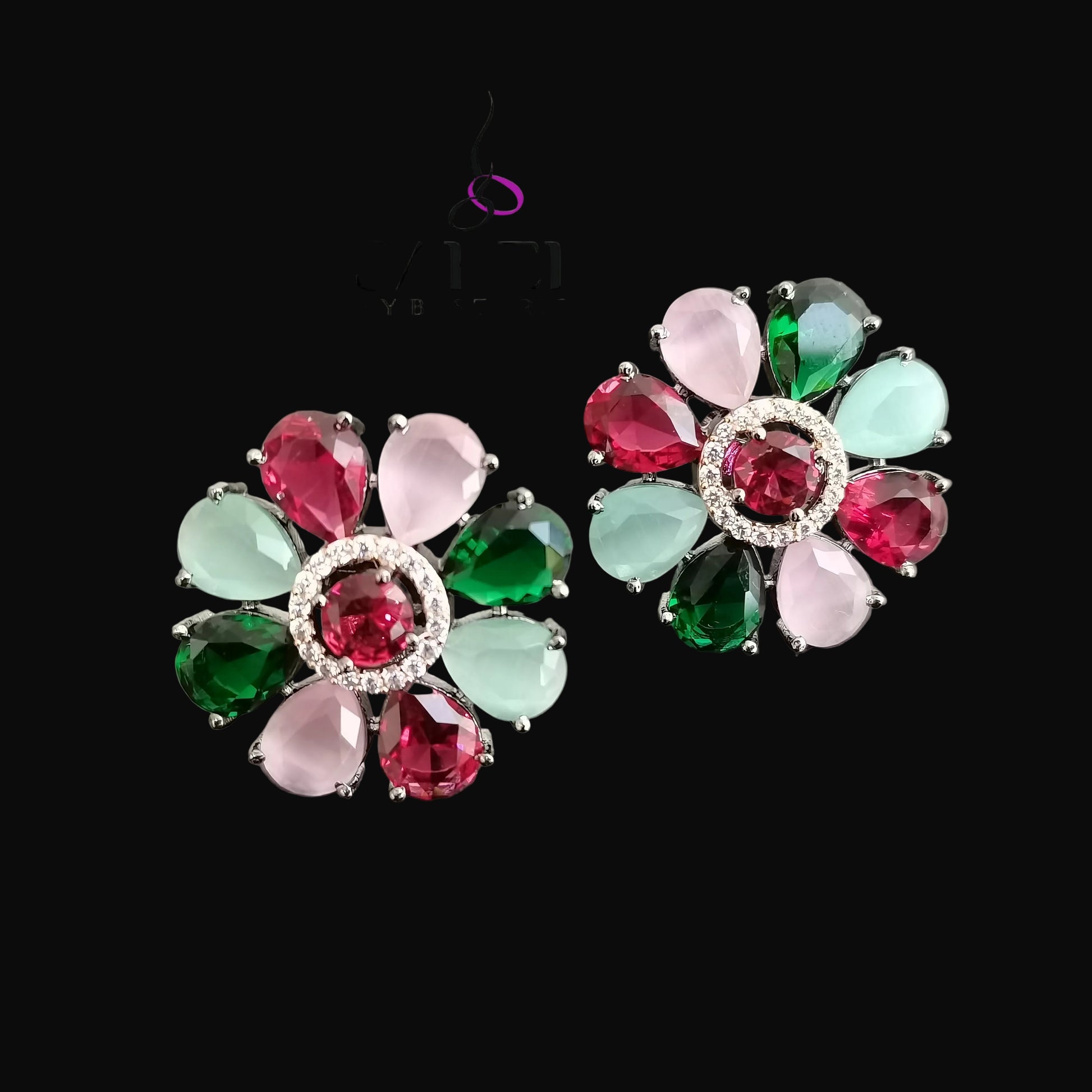 Colorful gemstone earrings with 'Saheli' branding on a gray background