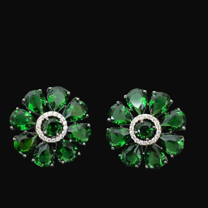 Pair of green gemstone earrings on a gray background