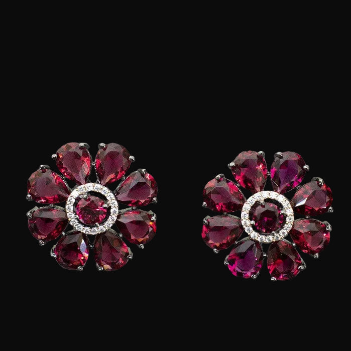 Pair of red gemstone earrings on a gray background
