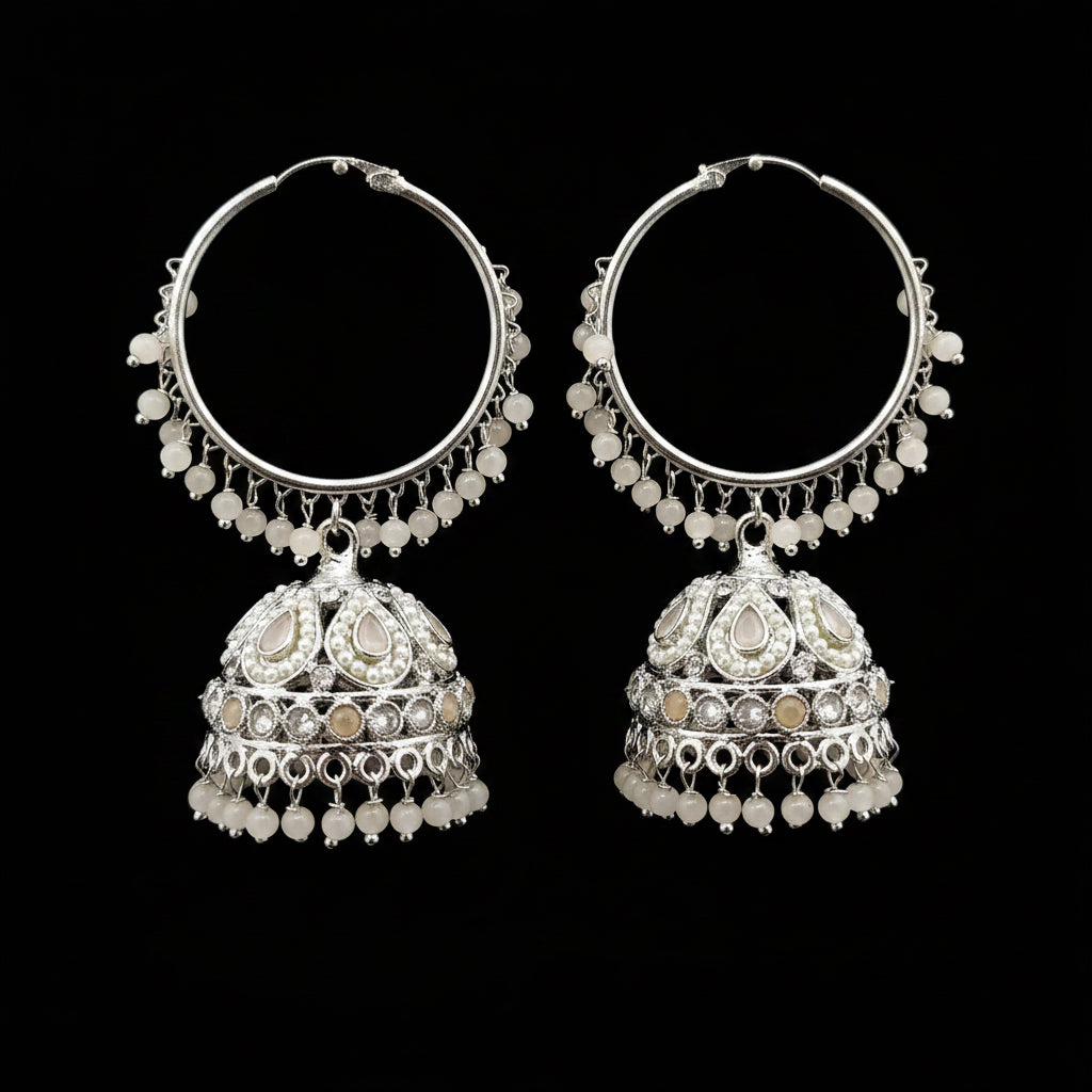 Pair of silver hoop earrings with intricate designs on a gray background