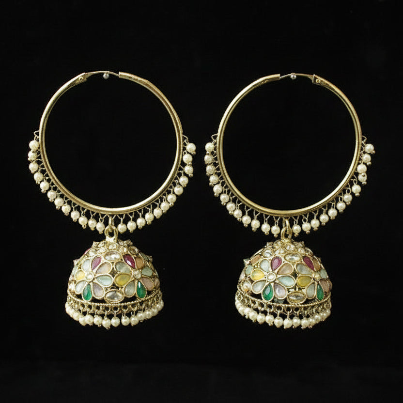 Pair of gold hoop earrings with colorful gemstones on a black background