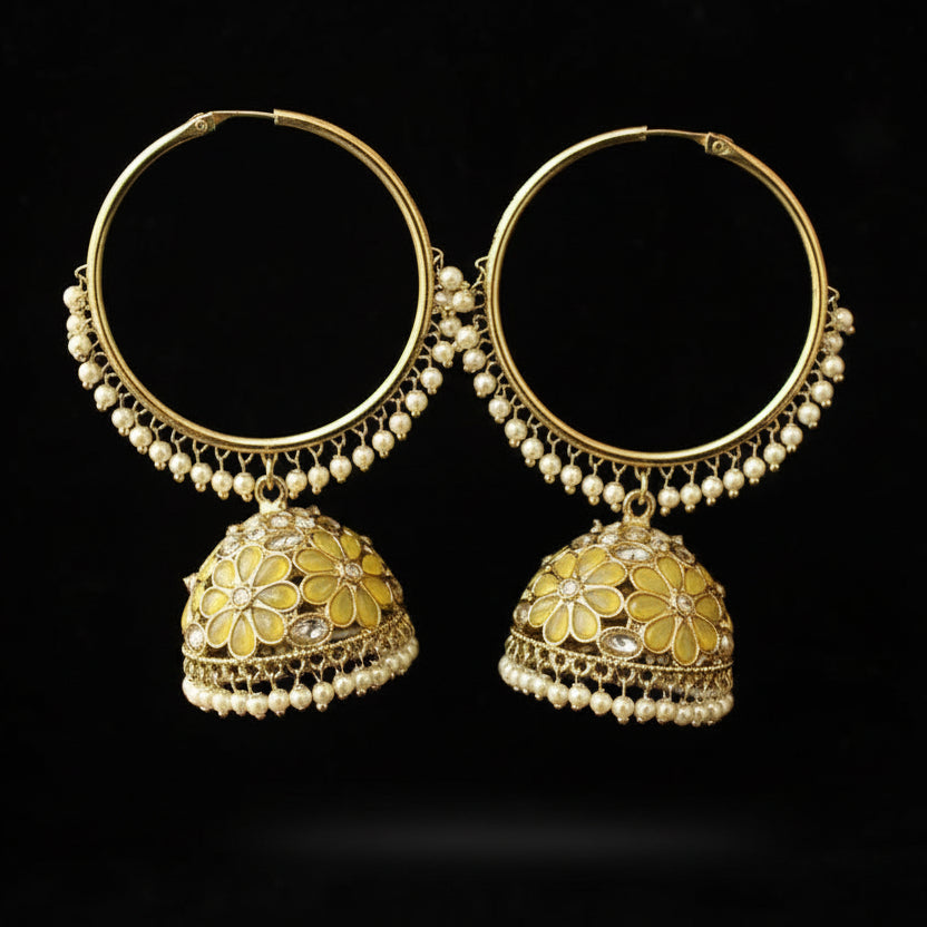 Pair of gold hoop earrings with floral designs on a black background