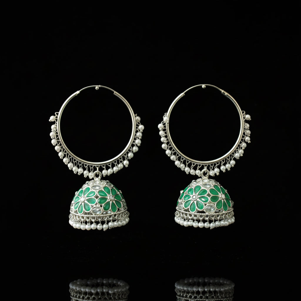 Pair of silver hoop earrings with green floral designs on a black background