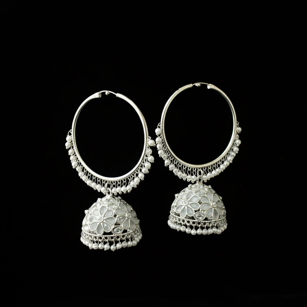 Pair of silver hoop earrings with floral designs on a black background