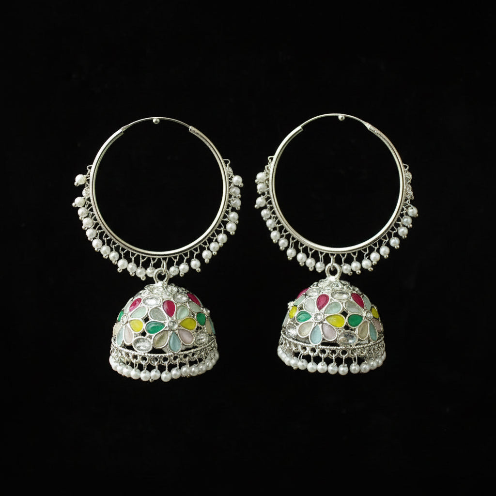 Pair of silver hoop earrings with colorful gemstones on a black background