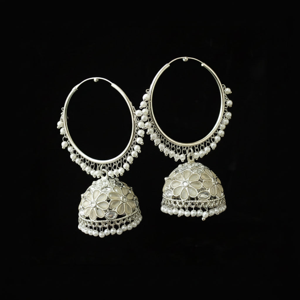 Pair of silver hoop earrings with floral designs on a black background