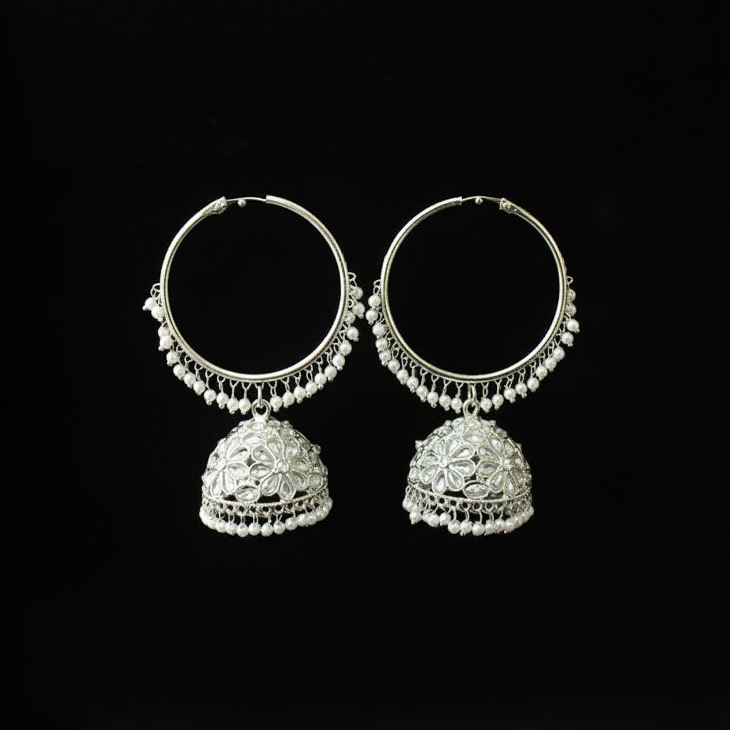 Silver hoop earrings with intricate designs on a black background