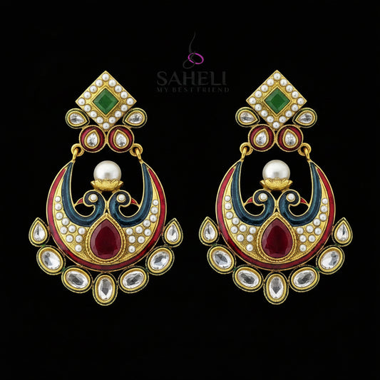 A pair of traditional Indian gold-plated earrings with red, green, and white enamel details, set against a dark reflective background with the brand logo 'SAHELI MY BEST FRIEND' at the top.