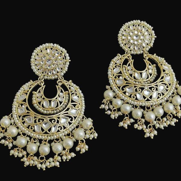Pair of gold and pearl earrings on a black background
